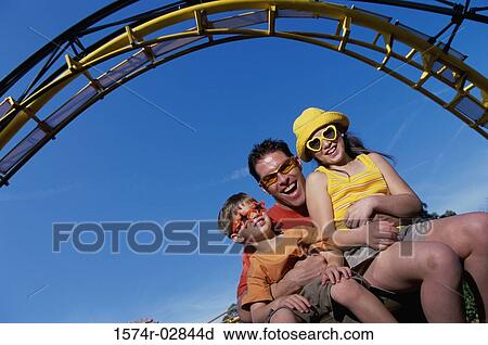Portrait of a father with his son and daughter on an amusement park ride View Large Photo Image Stock Image - Portrait of a father with his son and daughter on an amusement park ride. Fotosearch