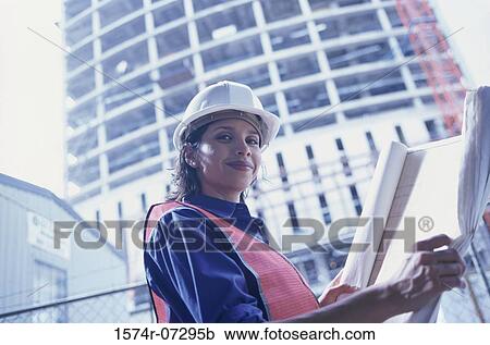 Portrait of a forewoman holding blueprints View Large Photo Image Stock Image - Portrait of a forewoman holding blueprints. Fotosearch