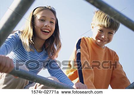 Portrait of a girl and a boy on monkey bars View Large Photo Image Stock Image - Portrait of a girl and a boy on monkey bars. Fotosearch