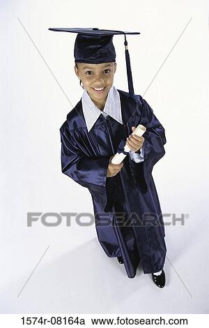 Stock Image - Portrait of a girl dressed in a graduation outfit holding a diploma. Fotosearch