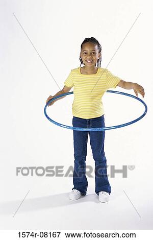 Portrait of a girl playing with a hula hoop View Large Photo Image Stock Photo - Portrait of a girl playing with a hula hoop. Fotosearch