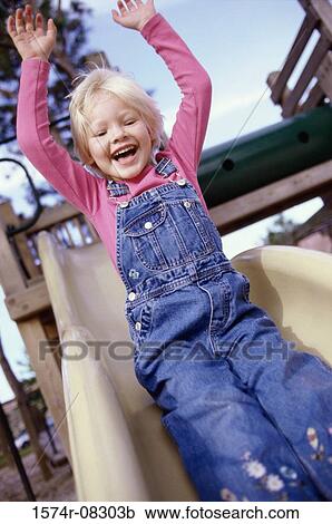Portrait of a girl sliding down a slide View Large Photo Image Stock Image - Portrait of a girl sliding down a slide. Fotosearch