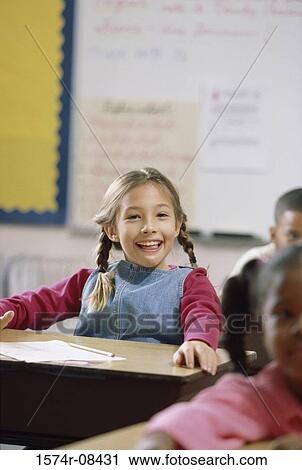 Portrait of a girl smiling in class View Large Photo Image Stock Image - Portrait of a girl smiling in class. Fotosearch