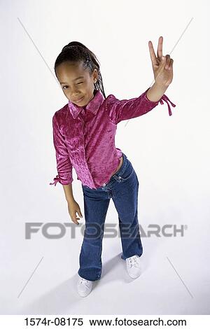 Portrait of a girl standing making the victory sign View Large Photo Image Stock Photography - Portrait of a girl standing making the victory sign. Fotosearch
