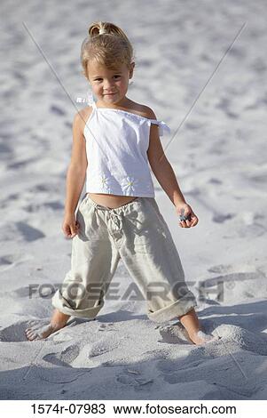 Portrait of a girl standing on the beach View Large Photo Image Stock Image - Portrait of a girl standing on the beach. Fotosearch