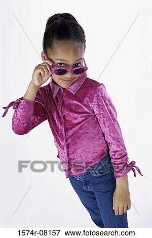 Portrait of a girl standing wearing sunglasses View Large Photo Image Stock Photo - Portrait of a girl standing wearing sunglasses. Fotosearch