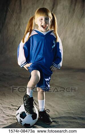 Portrait of a girl standing with her foot on a soccer ball View Large Photo Image Stock Image - Portrait of a girl standing with her foot on a soccer ball. Fotosearch