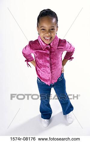 Portrait of a girl standing with her hands behind her back View Large Photo Image Stock Photograph - Portrait of a girl standing with her hands behind her back. Fotosearch