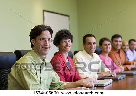 Stock Image - Portrait of a group of business executives in a meeting. Fotosearch