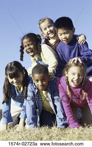 Stock Image - Portrait of a group of children making a human pyramid. Fotosearch