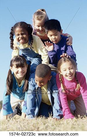 Stock Image - Portrait of a group of children making a human pyramid. Fotosearch
