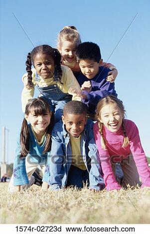 Portrait of a group of children making a human pyramid View Large Photo Image Stock Image - Portrait of a group of children making a human pyramid. Fotosearch