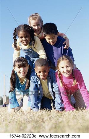 Portrait of a group of children making a human pyramid View Large Photo Image Stock Image - Portrait of a group of children making a human pyramid. Fotosearch