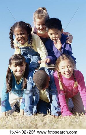 Stock Image - Portrait of a group of children making a human pyramid. Fotosearch
