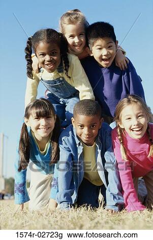 Portrait of a group of children making a human pyramid View Large Photo Image Stock Image - Portrait of a group of children making a human pyramid. Fotosearch