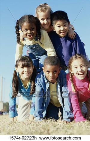 Portrait of a group of children making a human pyramid View Large Photo Image Stock Image - Portrait of a group of children making a human pyramid. Fotosearch