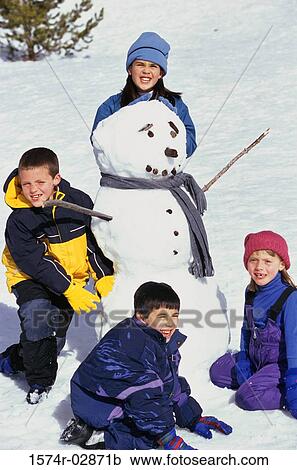 Portrait of a group of children making a snowman View Large Photo Image Stock Image - Portrait of a group of children making a snowman. Fotosearch