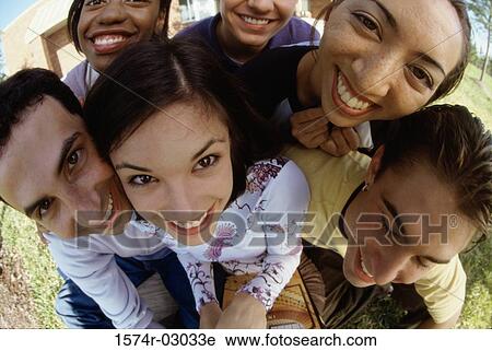 Stock Image - Portrait of a group of teenagers smiling. Fotosearch