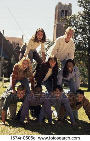 Stock Image - Portrait of a group of young people making a human pyramid. Fotosearch