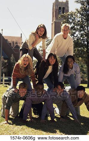 Stock Image - Portrait of a group of young people making a human pyramid. Fotosearch