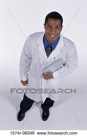 Portrait of a male doctor smiling View Large Photo Image Stock Photograph - Portrait of a male doctor smiling. Fotosearch