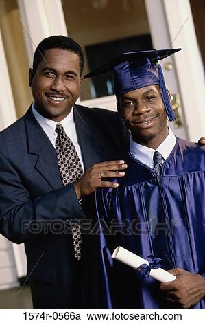Stock Image - Portrait of a male graduate with his father. Fotosearch
