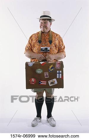 Portrait of a man holding a suitcase View Large Photo Image Stock Photo - Portrait of a man holding a suitcase. Fotosearch