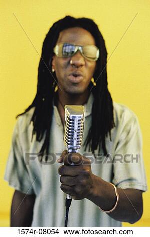 Picture - Portrait of a man singing into a microphone. Fotosearch