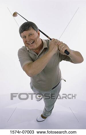 Portrait of a man standing holding a golf club View Large Photo Image Stock Image - Portrait of a man standing holding a golf club. Fotosearch