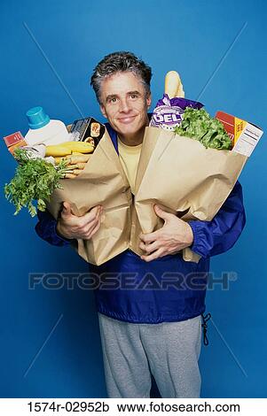 Portrait of a mature man carrying two grocery bags View Large Photo Image Stock Image - Portrait of a mature man carrying two grocery bags. Fotosearch