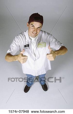 Stock Photo - Portrait of a mechanic showing thumbs up. Fotosearch