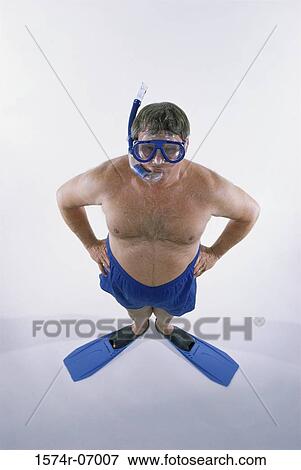 Portrait of a mid adult man in shorts wearing flippers with a mask and a snorkel View Large Photo Image Stock Photo - Portrait of a mid adult man in shorts wearing flippers with a mask and a snorkel. Fotosearch
