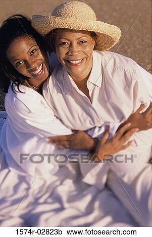 Stock Image - Portrait of a mother and her daughter smiling. Fotosearch