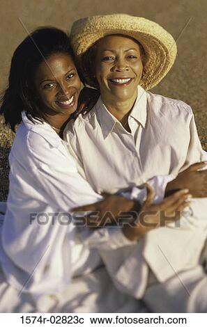 Stock Image - Portrait of a mother and her daughter smiling. Fotosearch