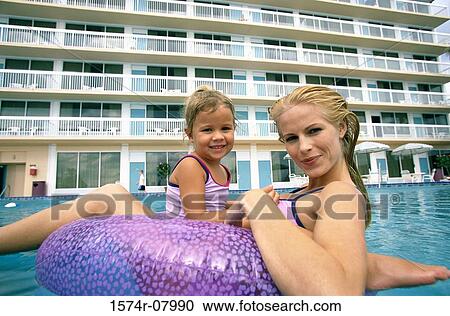 Portrait of a mother and her daughter playing in a swimming pool View Large Photo Image Stock Image - Portrait of a mother and her daughter playing in a swimming pool. Fotosearch
