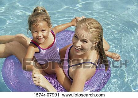 Portrait of a mother and her daughter playing in a swimming pool View Large Photo Image Stock Image - Portrait of a mother and her daughter playing in a swimming pool. Fotosearch