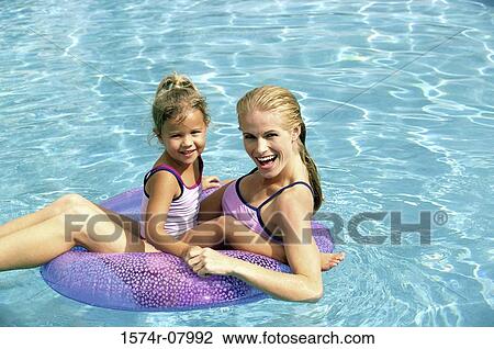 Portrait of a mother and her daughter playing in a swimming pool View Large Photo Image Stock Image - Portrait of a mother and her daughter playing in a swimming pool. Fotosearch