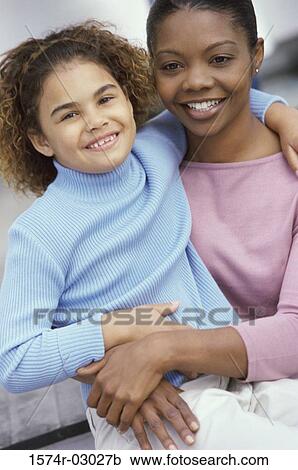 Portrait of a mother carrying her daughter View Large Photo Image Stock Image - Portrait of a mother carrying her daughter. Fotosearch