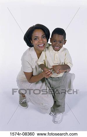 Stock Image - Portrait of a mother holding her son. Fotosearch