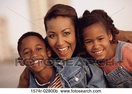 Portrait of a mother smiling with her son and daughter View Large Photo Image Stock Image - Portrait of a mother smiling with her son and daughter. Fotosearch