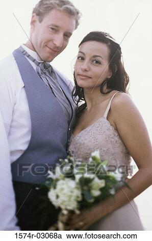 Stock Image - Portrait of a newlywed couple smiling. Fotosearch