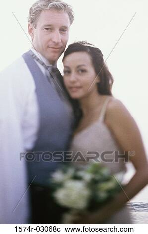 Portrait of a newlywed couple smiling View Large Photo Image Stock Image - Portrait of a newlywed couple smiling. Fotosearch