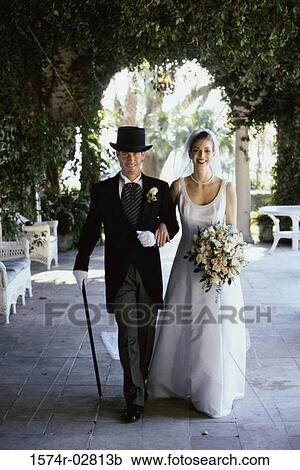 Stock Image - Portrait of a newlywed couple walking. Fotosearch