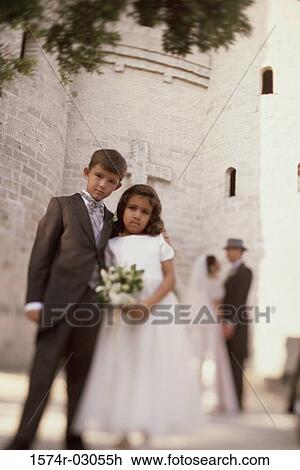 Portrait of a ring bearer and a flower girl standing in front of a church View Large Photo Image Stock Image - Portrait of a ring bearer and a flower girl standing in front of a church. Fotosearch