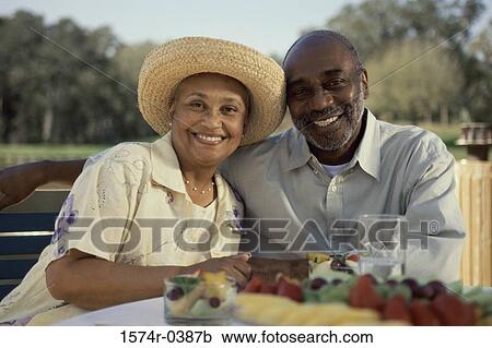 Portrait of a senior couple sitting together smiling View Large Photo Image Stock Image - Portrait of a senior couple sitting together smiling. Fotosearch