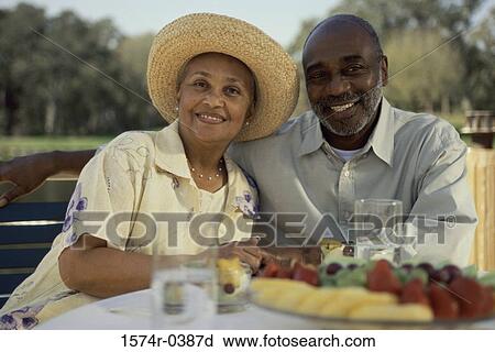 Portrait of a senior couple sitting together smiling View Large Photo Image Stock Image - Portrait of a senior couple sitting together smiling. Fotosearch