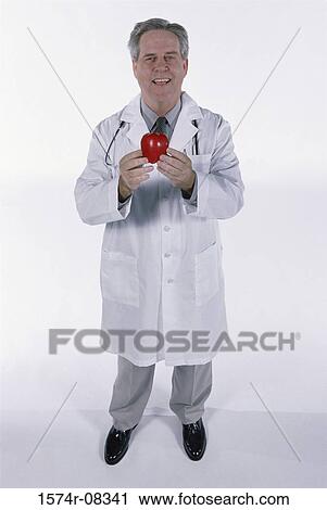 Portrait of a senior man holding an apple View Large Photo Image Stock Image - Portrait of a senior man holding an apple. Fotosearch