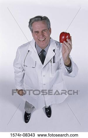 Portrait of a senior man holding an apple View Large Photo Image Stock Image - Portrait of a senior man holding an apple. Fotosearch