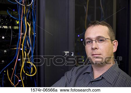 Portrait of a technician in a server room View Large Photo Image Stock Image - Portrait of a technician in a server room. Fotosearch