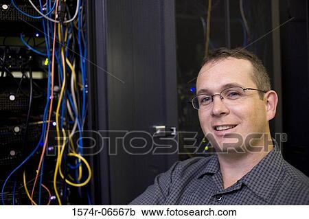 Portrait of a technician in a server room View Large Photo Image Stock Image - Portrait of a technician in a server room. Fotosearch